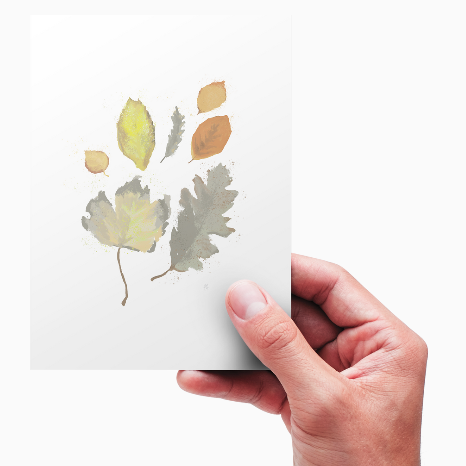 A hand holds a white piece of paper card with a digital paingting of seven leaves on it.